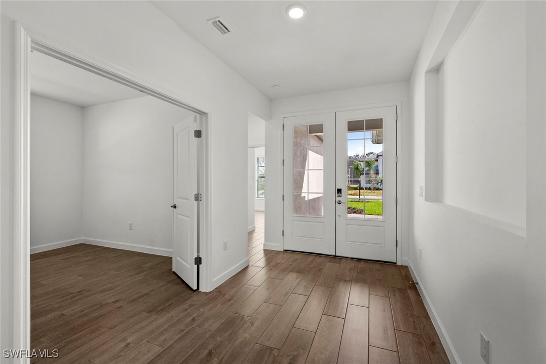 20446 Napa Loop Estero, FL 33928 - Photo 6 of 42 wooden floor in an empty room with a window