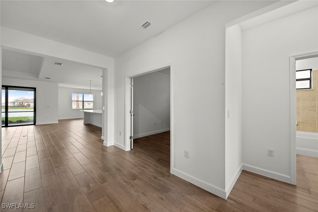 20446 Napa Loop Estero, FL 33928 - Photo 7 of 42 wooden floor in an empty room with a window