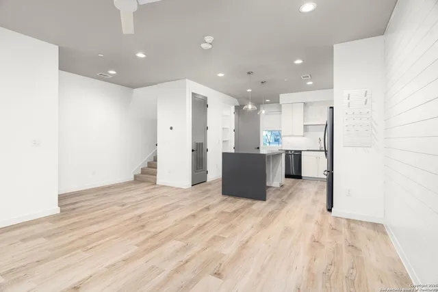 a view of a kitchen with a sink and a refrigerator