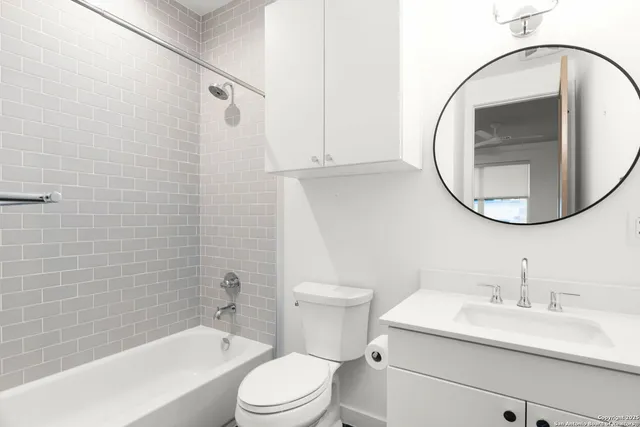 a bathroom with a sink a toilet and a mirror