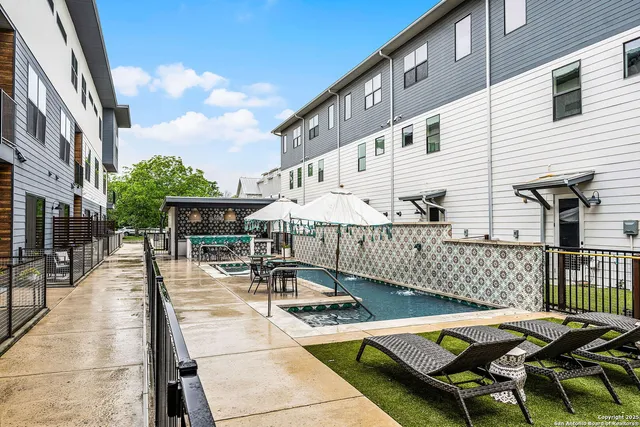 a view of a patio with a table and chairs