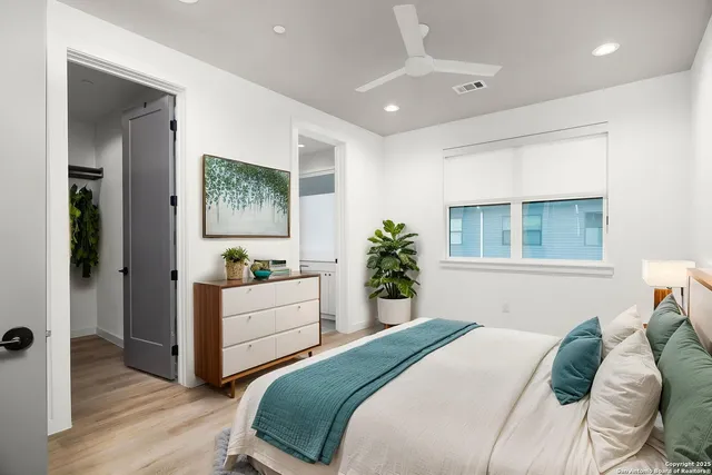 a bedroom with a bed and a window