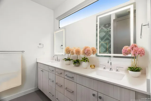 a bathroom with a sink mirror and