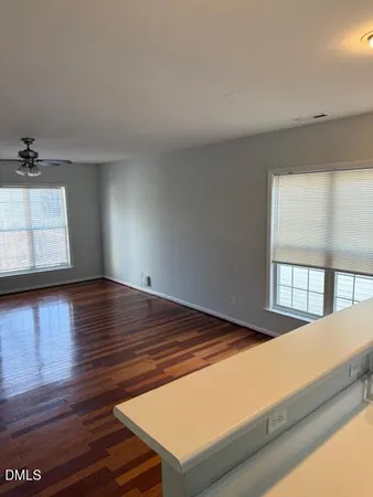 a view of a room with wooden floor and window