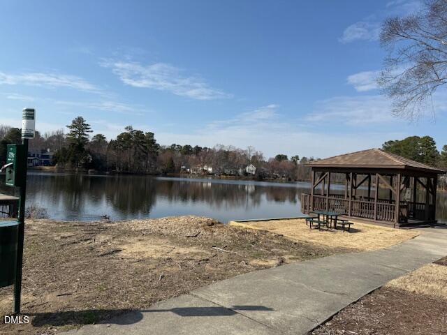 2036 Turtle Point Drive Raleigh, NC 27604 - Photo 27 of 27 a backyard of a house with lake view and a large tree