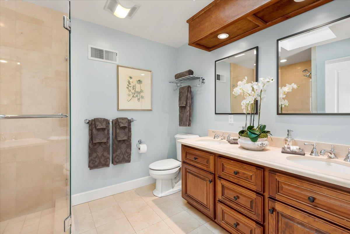 466 Springer Road Los Altos, CA 94024 - Photo 30 of 52 a spacious bathroom with a toilet a double vanity sink and a mirror