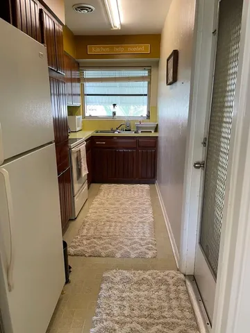 a bathroom with a tub shower and sink