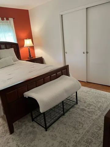 a bedroom with a bed and lamp