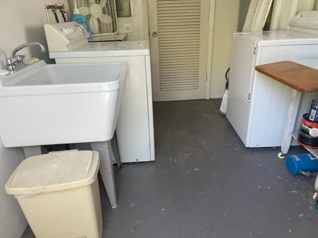a utility room with a sink washer and dryer