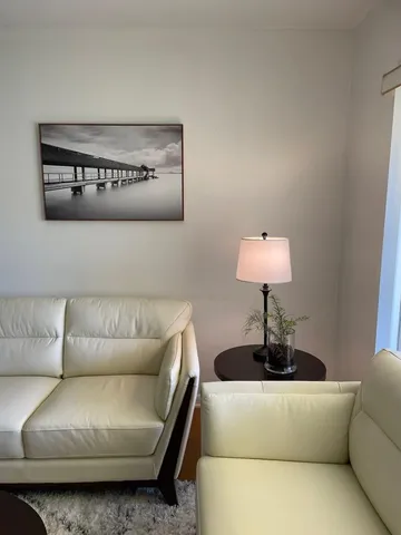 a living room with furniture and a lamp