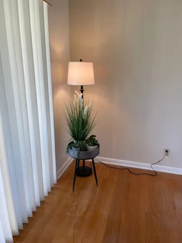 a view of a room with a sink and wooden floor