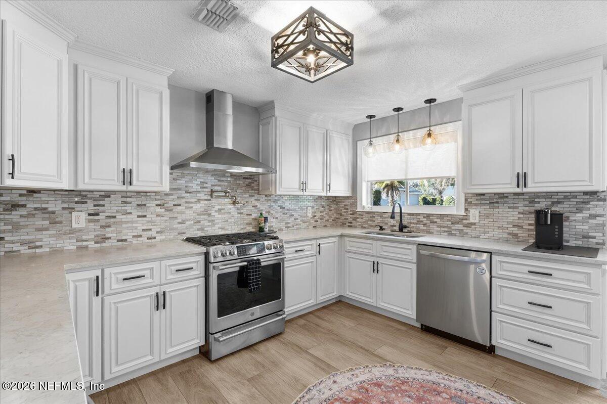 6215 West Shores Road Fleming Island, FL 32003 - Photo 24 of 103 a kitchen with granite countertop white cabinets and white stainless steel appliances