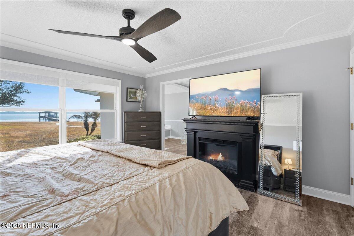 6215 West Shores Road Fleming Island, FL 32003 - Photo 33 of 103 a bedroom with a bed and a fireplace