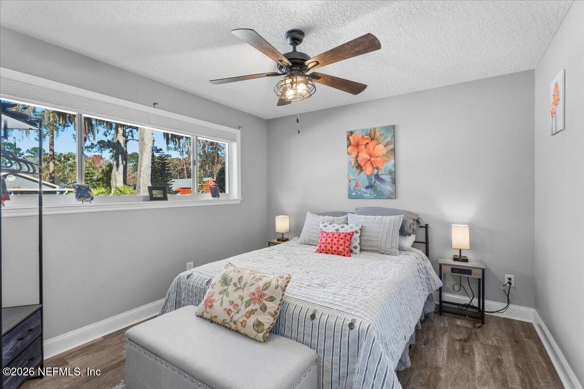 6215 West Shores Road Fleming Island, FL 32003 - Photo 39 of 103 a bedroom with a bed and a chandelier