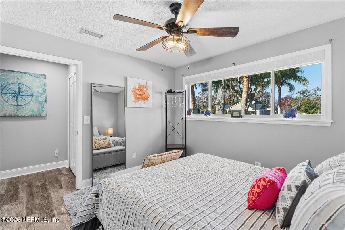 6215 West Shores Road Fleming Island, FL 32003 - Photo 40 of 103 a bedroom with a bed and a chandelier