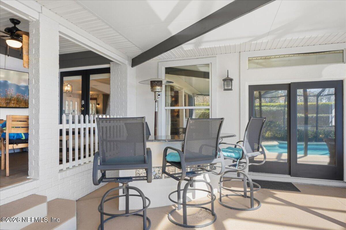 6215 West Shores Road Fleming Island, FL 32003 - Photo 47 of 103 a view of a dining room with furniture wooden floor and floor to ceiling windows