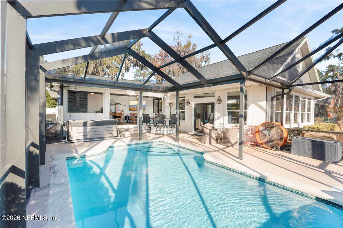 6215 West Shores Road Fleming Island, FL 32003 - Photo 49 of 103 a view of a patio with dining table and chairs with wooden floor