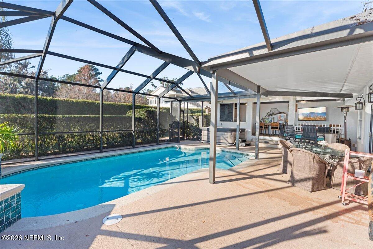6215 West Shores Road Fleming Island, FL 32003 - Photo 52 of 103 a view of a patio with table and chairs potted plants with floor to ceiling window