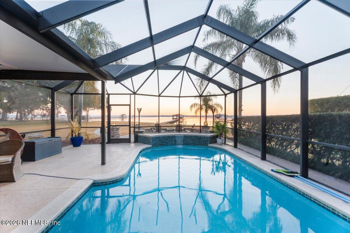 6215 West Shores Road Fleming Island, FL 32003 - Photo 7 of 103 a view of a swimming pool with a couches and wooden floor