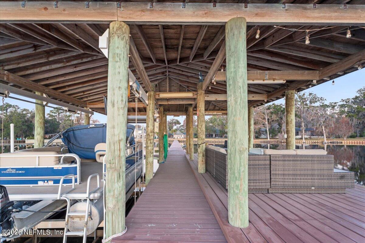 6215 West Shores Road Fleming Island, FL 32003 - Photo 71 of 103 a view of a porch with wooden floor and stairs