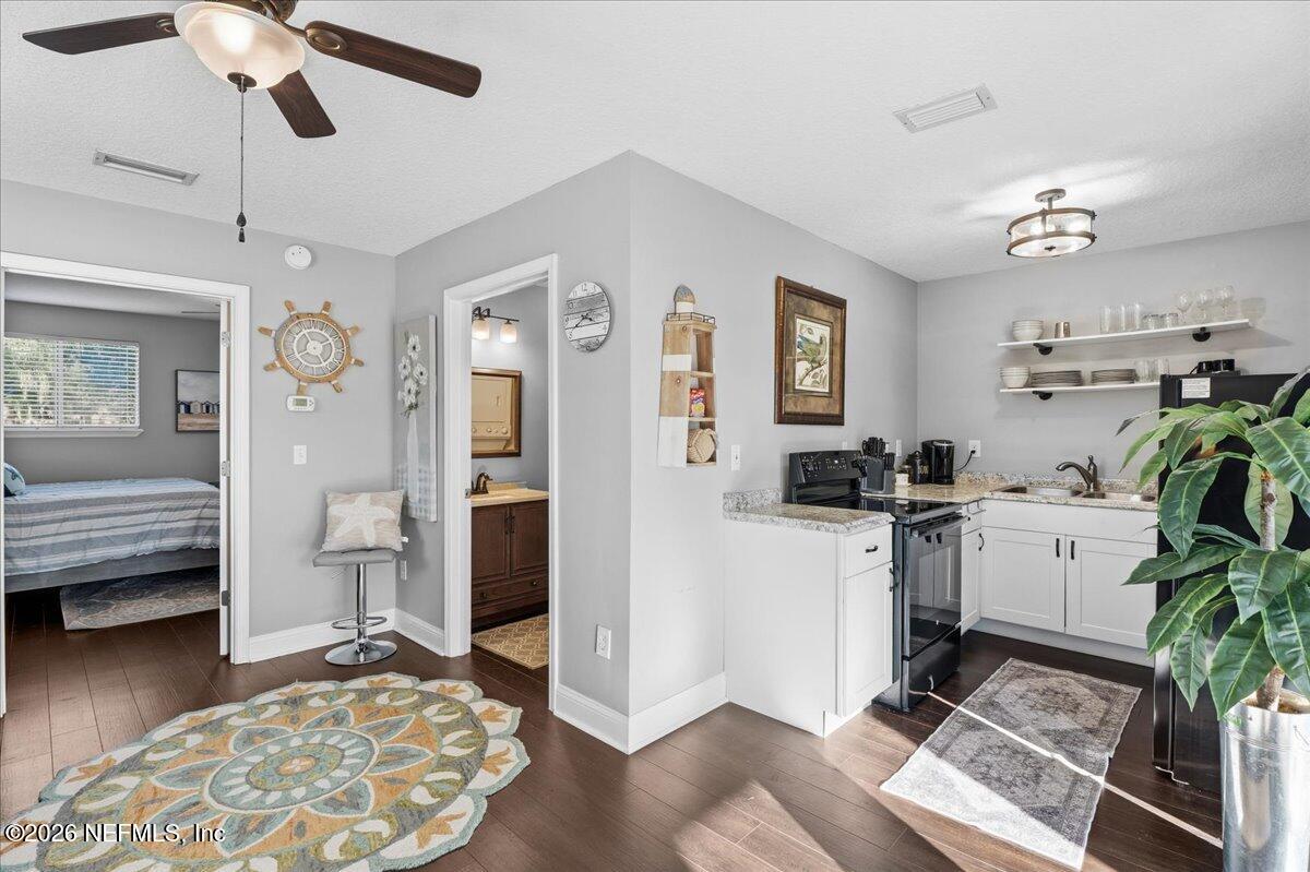 6215 West Shores Road Fleming Island, FL 32003 - Photo 80 of 103 a kitchen with a refrigerator and a stove