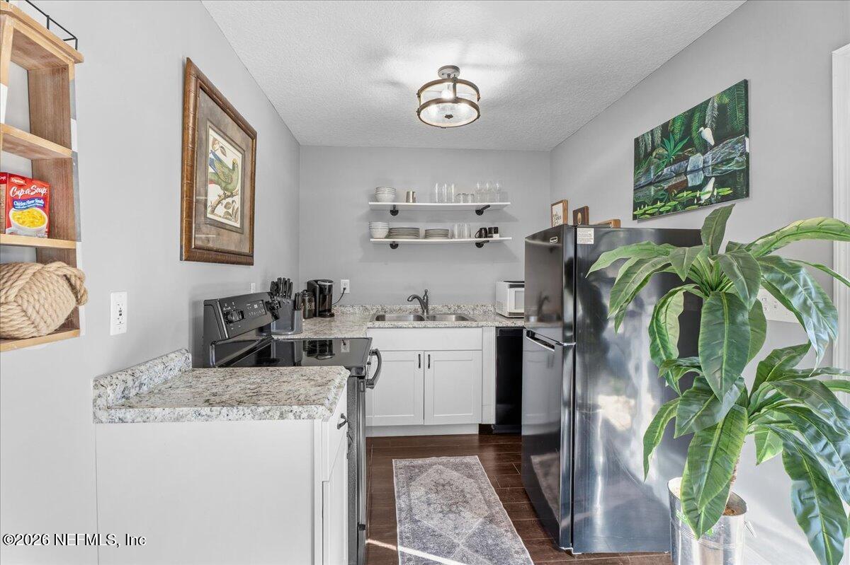 6215 West Shores Road Fleming Island, FL 32003 - Photo 81 of 103 a kitchen with appliances a sink and cabinets