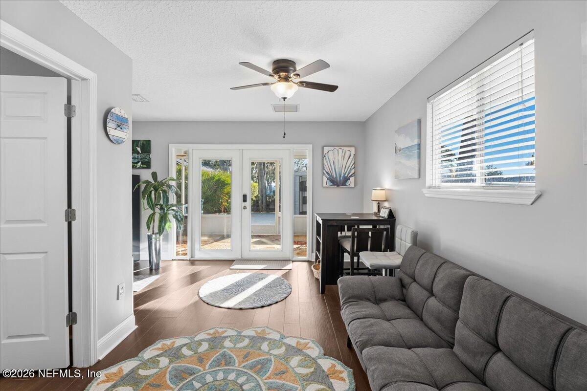 6215 West Shores Road Fleming Island, FL 32003 - Photo 83 of 103 a living room with furniture and a floor to ceiling window