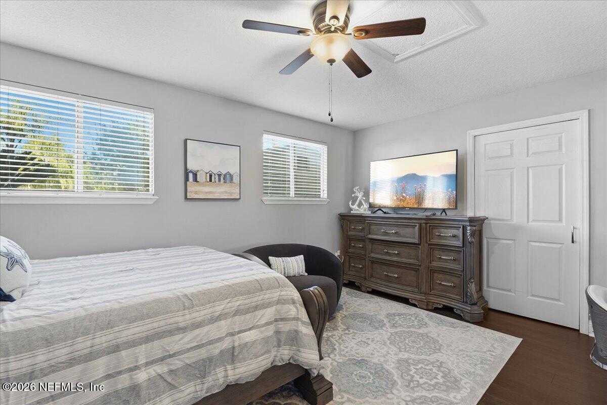 6215 West Shores Road Fleming Island, FL 32003 - Photo 86 of 103 a bedroom with a bed and wooden floor