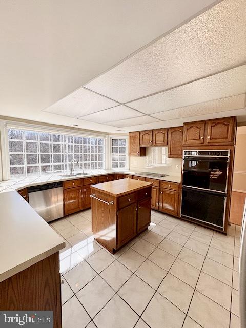 6825 Spring Beauty Court Springfield, VA 22152 - Photo 11 of 51 a kitchen with stainless steel appliances kitchen island granite countertop a stove a sink and a refrigerator