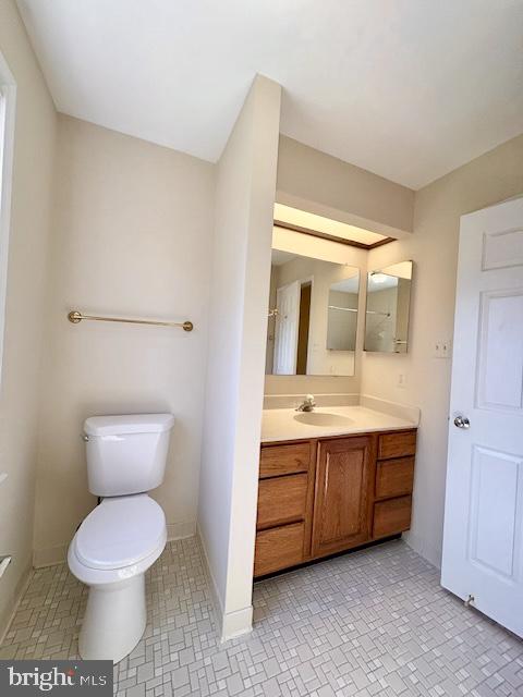 6825 Spring Beauty Court Springfield, VA 22152 - Photo 43 of 51 a bathroom with a toilet sink and mirror