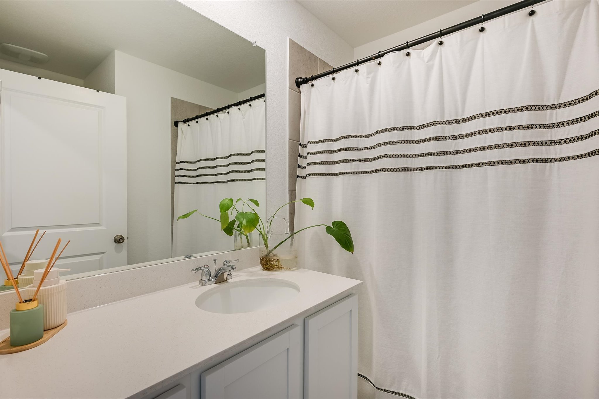 1701 Chapel Ranch Road Georgetown, TX 78628 - Photo 12 of 28 Smooth stone countertops and crisp white finishes define this classic secondary bathroom layout.