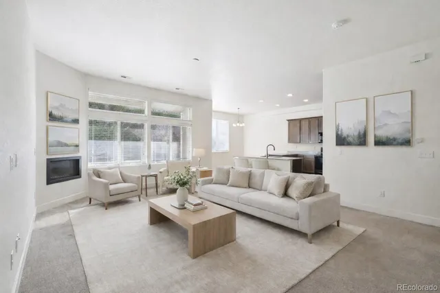 a view of kitchen with refrigerator and white cabinets
