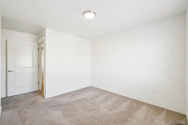 a view of an empty room with a ceiling fan