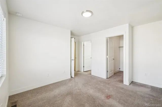 a spacious bathroom with a granite countertop sink a mirror and a shower