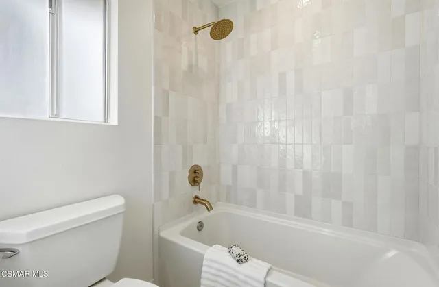 a bathroom with a bathtub and a toilet