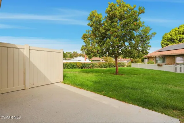 a view of an house with backyard space and garden