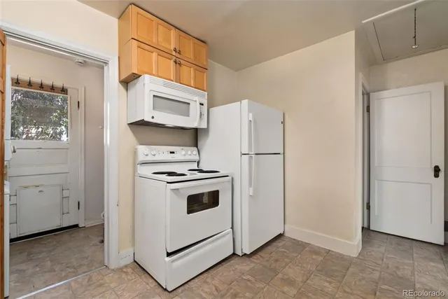 a kitchen with cabinets and white stainless steel appliances