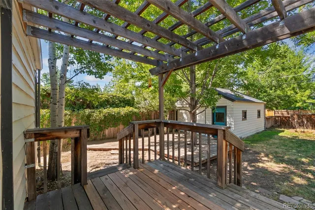 a view of a roof deck with wooden floor and fence