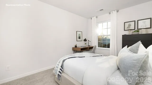 a bedroom with a bed and a large mirror