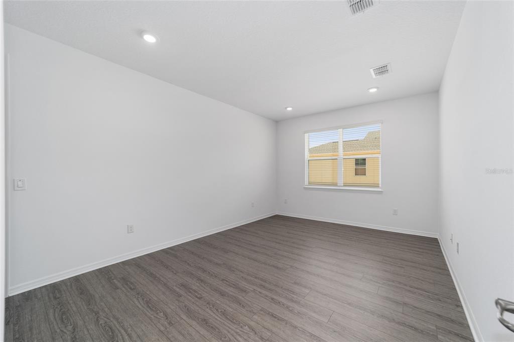 7232 Southwest 63rd Street Ocala, FL 34474 - Photo 12 of 54 an empty room with wooden floor and windows