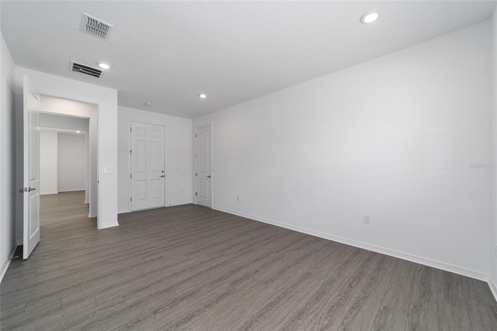 7232 Southwest 63rd Street Ocala, FL 34474 - Photo 13 of 54 a view of an empty room with wooden floor