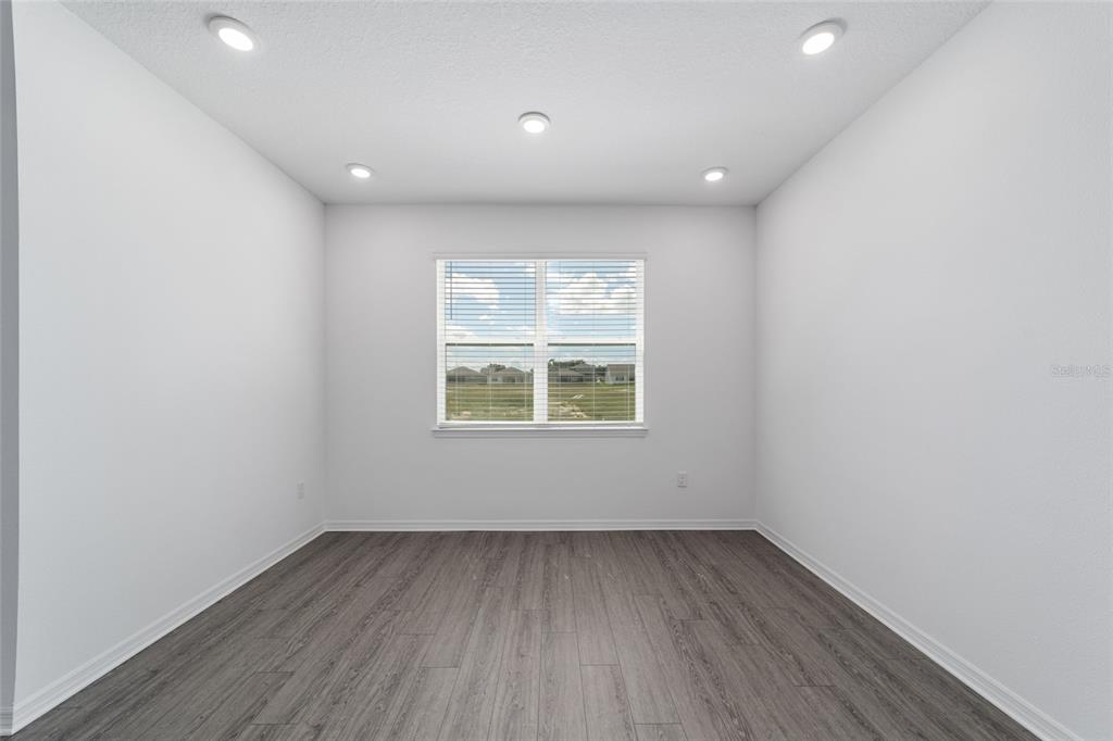 7232 Southwest 63rd Street Ocala, FL 34474 - Photo 20 of 54 a view of an empty room with wooden floor and a window