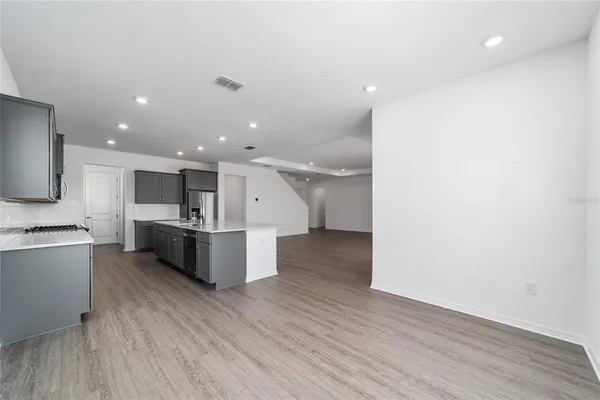 a large kitchen with stainless steel appliances and a large counter top