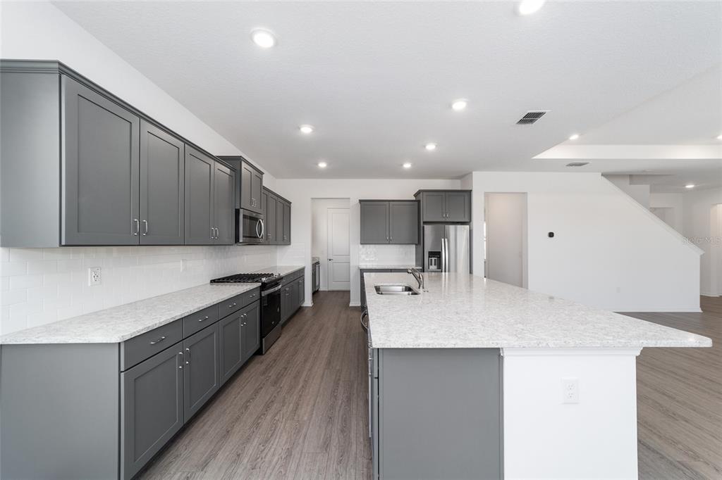 7232 Southwest 63rd Street Ocala, FL 34474 - Photo 22 of 54 a large kitchen with stainless steel appliances and a large counter top