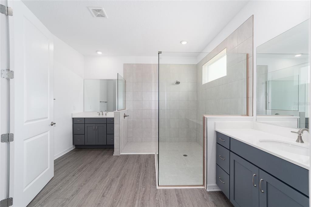 7232 Southwest 63rd Street Ocala, FL 34474 - Photo 29 of 54 a bathroom with a double vanity sink mirror and shower