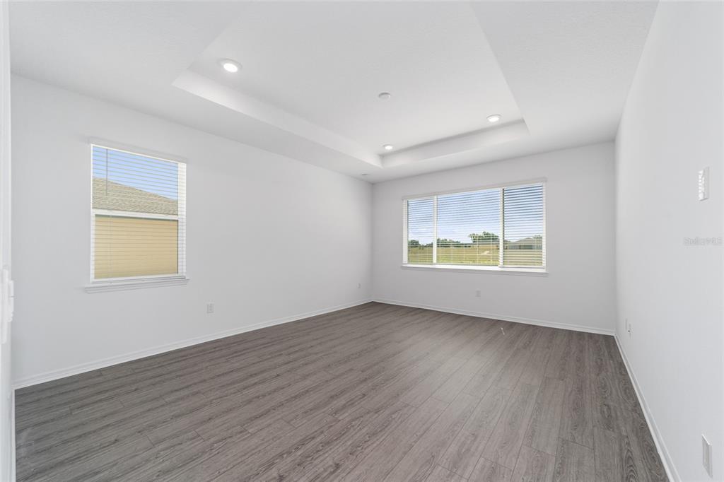 7232 Southwest 63rd Street Ocala, FL 34474 - Photo 33 of 54 an empty room with wooden floor and windows