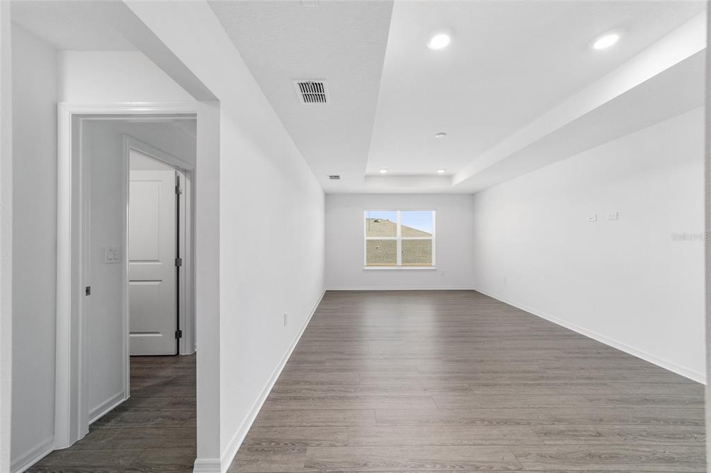 7232 Southwest 63rd Street Ocala, FL 34474 - Photo 37 of 54 a view of an empty room with wooden floor and a window