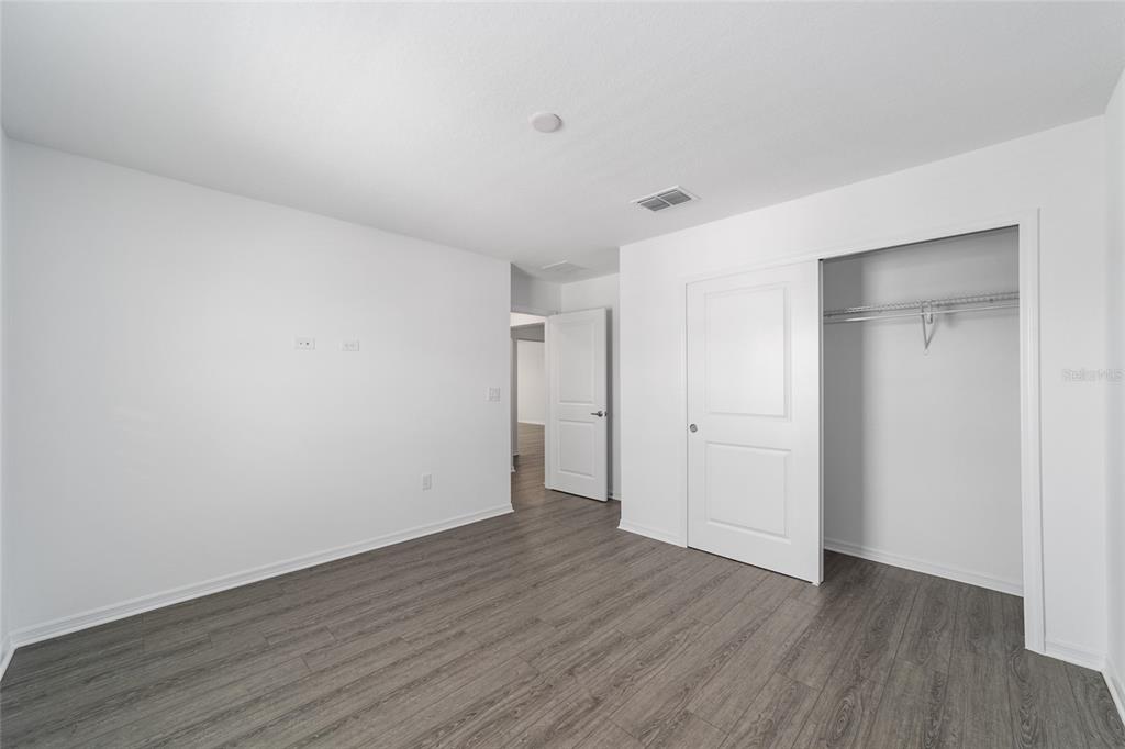 7232 Southwest 63rd Street Ocala, FL 34474 - Photo 39 of 54 a view of an empty room with wooden floor