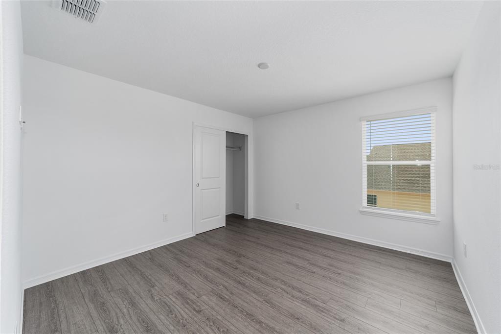 7232 Southwest 63rd Street Ocala, FL 34474 - Photo 42 of 54 an empty room with wooden floor and windows