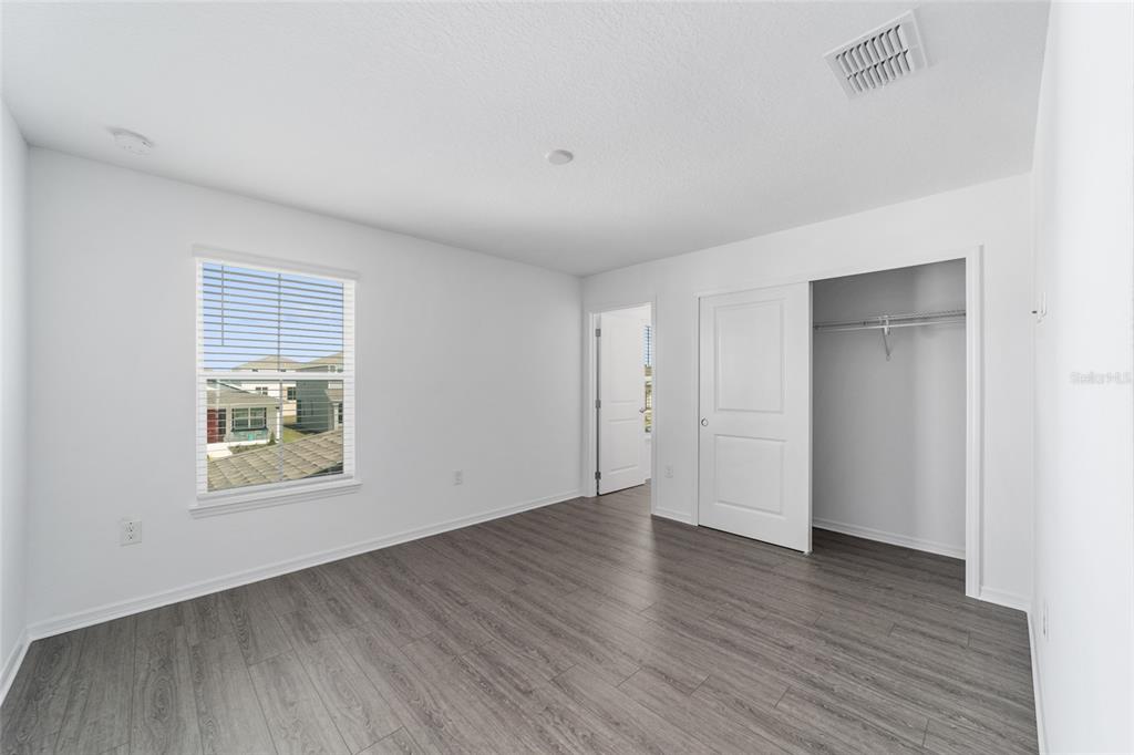 7232 Southwest 63rd Street Ocala, FL 34474 - Photo 45 of 54 an empty room with wooden floor and windows